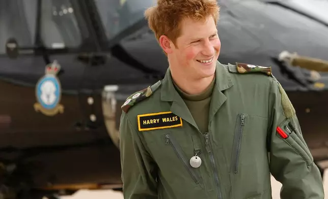 FILE - In this Thursday, June 18, 2009 file photo Britain's Prince Harry smiles during a photo call at RAF (Royal Air Force) Shawbury in Shropshire, England. (AP Photo/Kirsty Wigglesworth, File)