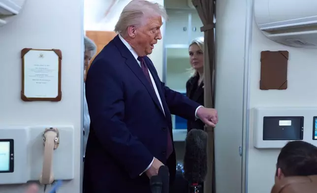 President Donald Trump discuses bruising on his hand with reporters aboard Air Force One after leaving the World Economic Forum in Davos for Washington, Thursday, Jan. 22, 2026. (AP Photo/Evan Vucci)
