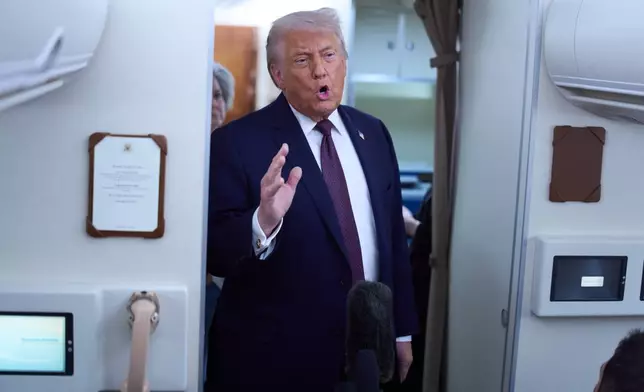President Donald Trump speaks with reporters aboard Air Force One after leaving the World Economic Forum in Davos for Washington, Thursday, Jan. 22, 2026. (AP Photo/Evan Vucci)