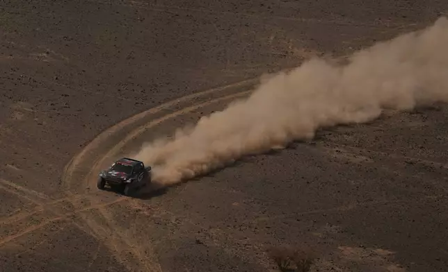 Driver Joao Ferreira and co-driver Filipe Palmeiro compete during the seventh stage of the Dakar Rally between Riyadh and Wadi Ad Dawasir, Saudi Arabia, Sunday, Jan.11, 2026. (AP Photo/Thibault Camus)