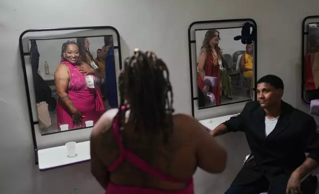 Inmates get ready backstage to sing in the Voice of Freedom rehabilitation program event at the Djanira Dolores de Oliveira women's penitentiary in Rio de Janeiro, Friday, Jan. 23, 2026. (AP Photo/Silvia Izquierdo)