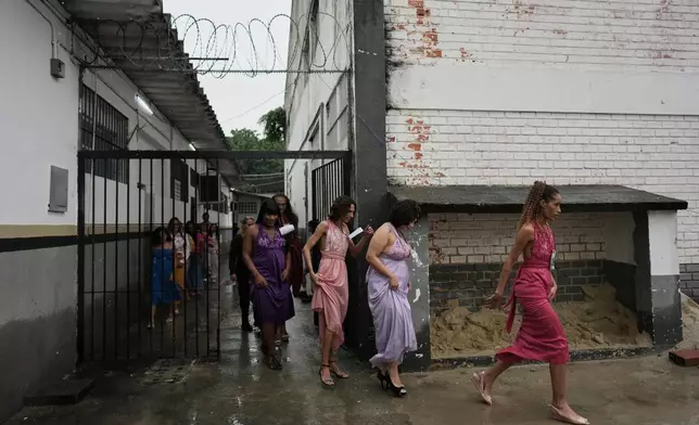 Inmate walk to the stage to compete in the Voice of Freedom rehabilitation program singing contest at the Djanira Dolores de Oliveira women's penitentiary in Rio de Janeiro, Friday, Jan. 23, 2026. (AP Photo/Silvia Izquierdo)