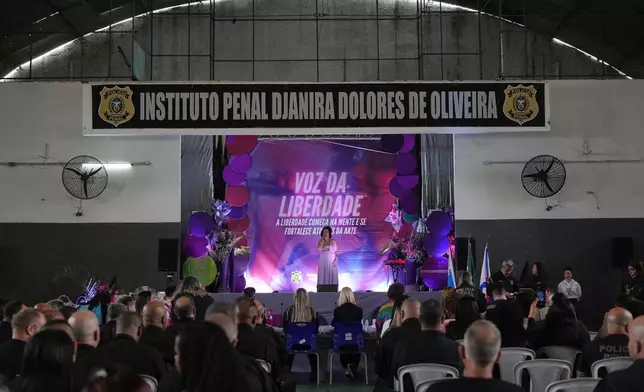 An inmate performs on stage in the Voice of Freedom rehabilitation program singing contest at the Djanira Dolores de Oliveira women's penitentiary in Rio de Janeiro, Friday, Jan. 23, 2026. (AP Photo/Silvia Izquierdo)