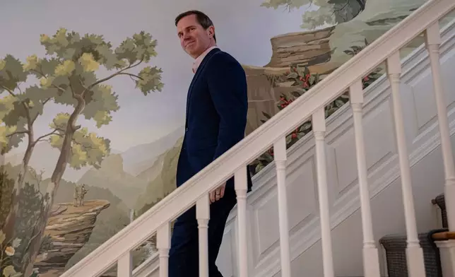 Kentucky Gov. Andy Beshear walks down the stairs before an interview, Monday, Jan. 12, 2026, in Frankfort, Ky. (AP Photo/Jon Cherry)