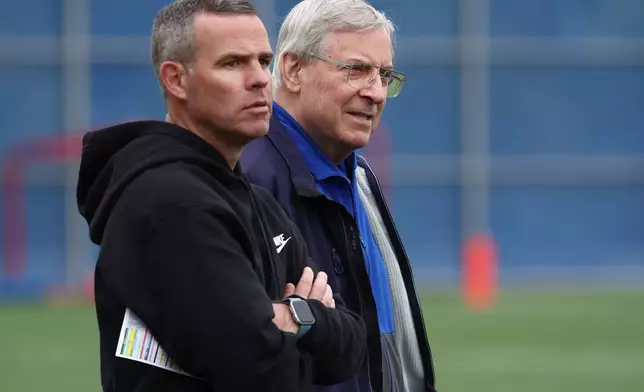 FILE - Buffalo Bills general manager Brandon Beane,Left and owner Terry Pegula look on during NFL football practice in Orchard Park, N.Y., Tuesday, June 11, 2024. (AP Photo/Jeffrey T. Barnes, File)