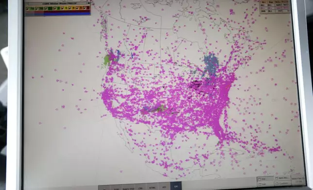 FILE - In this Wednesday, Feb. 11, 2015, photo, a computer screen shows all air traffic in real time over North America in the control tower at O'Hare International Airport in Chicago. (AP Photo/M. Spencer Green, File)