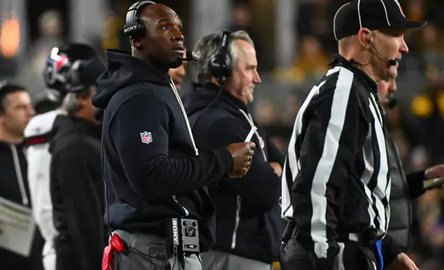 Houston Texans head coach DeMeco Ryans, left, stands on the sideline during the first half of an NFL wild-card playoff football game against the Houston Texans, Monday, Jan. 12, 2026, in Pittsburgh. (AP Photo/Justin Berl)