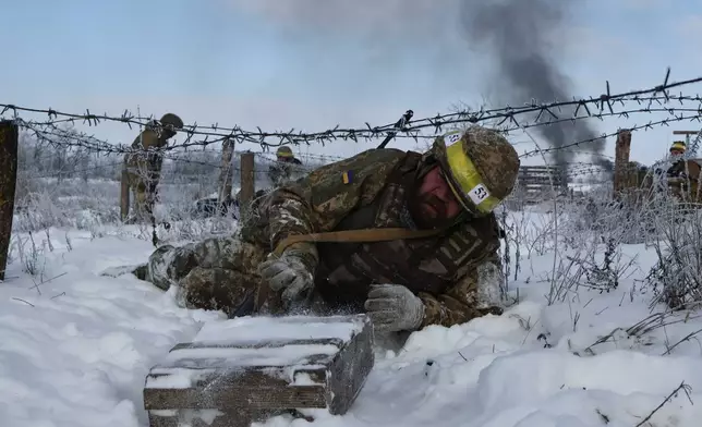 In this photo provided by Ukraine's 65th Mechanized Brigade press service, recruits perform drills at a training ground in the Zaporizhzhia region, Ukraine, Thursday, Jan. 1, 2026. (Andriy Andriyenko/Ukraine's 65th Mechanized Brigade via AP)