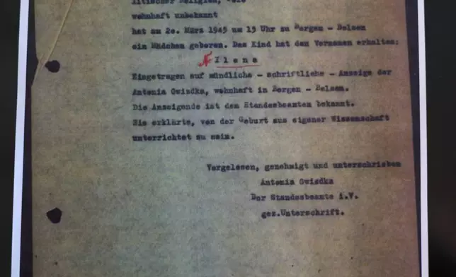 A Photo of the birth certificate of Holocaust survivor Ilana Shalem-Kantorowics, born in the Nazi Bergen-Belsen concentration camp in 1946 , is on display in Tel Aviv, Israel, Jan. 26, 2026. (AP Photo/Ariel Schalit)
