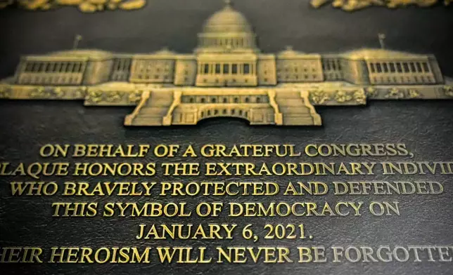A replica plaque commemorating the Jan. 6, 2021 Capitol riot hangs outside the office of Speaker Emerita Nancy Pelosi, D-Calif., Tuesday, Dec. 30, 2025, at the Longworth House Office Building on Capitol Hill in Washington. (AP Photo/Julia Demaree Nikhinson)