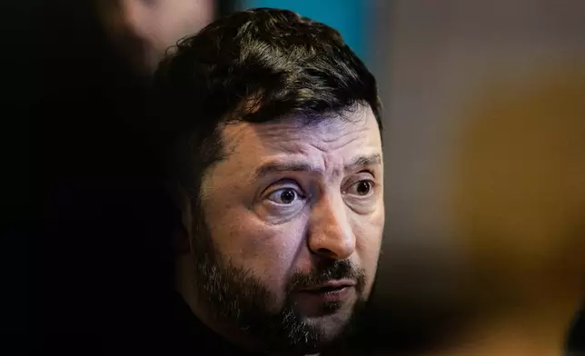 Ukraine's President Volodymyr Zelenskyy talks to the media at the Annual Meeting of the World Economic Forum in Davos, Switzerland, Thursday, Jan. 22, 2026. (AP Photo/Markus Schreiber)