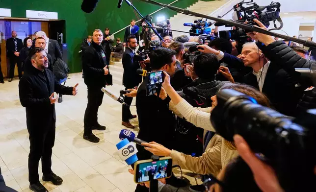 Ukraine's President Volodymyr Zelenskyy talks to the media at the Annual Meeting of the World Economic Forum in Davos, Switzerland, Thursday, Jan. 22, 2026. (AP Photo/Markus Schreiber)