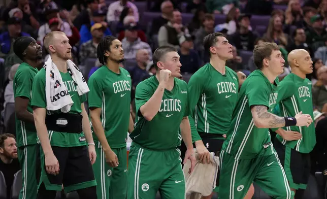 The Boston Celtics bench looks on during the second half of an NBA basketball game against the Sacramento Kings, Thursday, Jan. 1, 2026, in Sacramento, Calif. (AP Photo/Scott Marshall)
