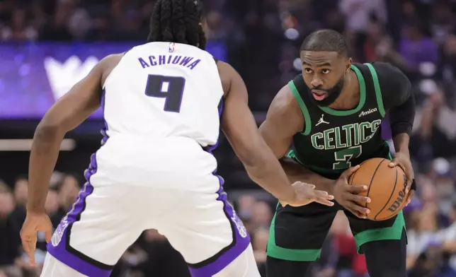 Boston Celtics guard Jaylen Brown (7) is guarded by Sacramento Kings forward Precious Achiuwa (9) during the first half of an NBA basketball game Thursday, Jan. 1, 2026, in Sacramento, Calif. (AP Photo/Scott Marshall)