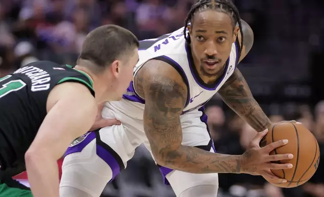 Sacramento Kings guard Demar Derozan, right, looks on while being guarded by Boston Celtics guard Payton Pritchard, left, during the second half of an NBA basketball game Thursday, Jan. 1, 2026, in Sacramento, Calif. (AP Photo/Scott Marshall)