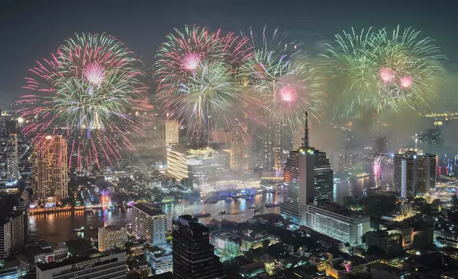 FILE - Fireworks explode over Chao Phraya River during New Year celebrations in Bangkok, Thailand, Jan. 1, 2026. (AP Photo/Sakchai Lalit, File)