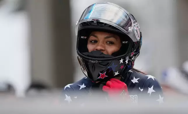 FILE - Winner Kaysha Love of the United States celebrates after the women's monobob race at the Bobsleigh World Cup in Innsbruck, Austria, Saturday, Nov. 29, 2025. (AP Photo/Matthias Schrader, File)