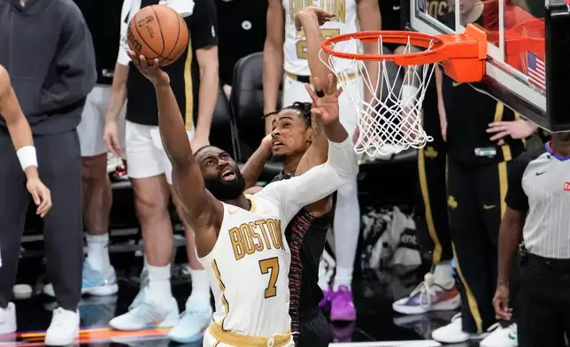 Boston Celtics guard Jaylen Brown (7) shoots over Brooklyn Nets center Nic Claxton, back, during the first half of an NBA basketball game, Friday, Jan. 23, 2026, in New York. (AP Photo/Yuki Iwamura)