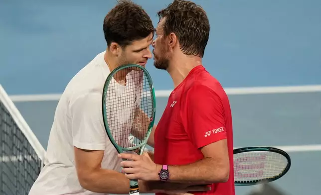 Hubert Hurkacz of Poland, left, and Stan Wawrinka of Switzerland meet at the net after Hurkacz won their final match at the United Cup tennis tournament in Sydney, Sunday, Jan. 11, 2026. (AP Photo/Rick Rycroft)