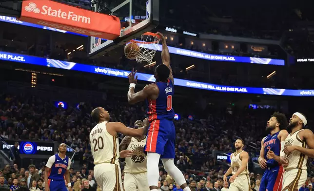 Detroit Pistons center Jalen Duren (0) dunks against Golden State Warriors center Al Horford (20) during the first half of an NBA basketball game in San Francisco, Friday, Jan. 30, 2026. (AP Photo/Jed Jacobsohn)