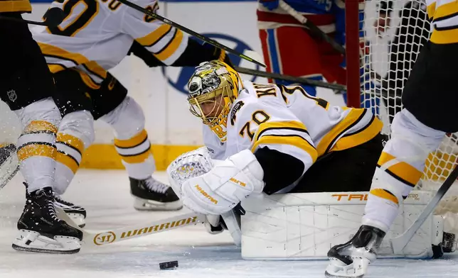 Boston Bruins goalie Joonas Korpisalo (70) prepares to cover the puck during the first period of an NHL hockey game against the New York Rangers Monday, Jan. 26, 2026, in New York. (AP Photo/John Munson)