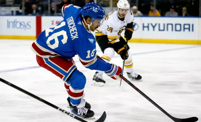 New York Rangers center Vincent Trocheck (16) skates past Boston Bruins center Elias Lindholm (28) during the first period of an NHL hockey game Monday, Jan. 26, 2026, in New York. (AP Photo/John Munson)