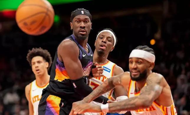 Phoenix Suns center Mark Williams (15) loses the ball against Atlanta Hawks forward Onyeka Okongwu (17) during the second half of an NBA basketball game, Friday, Jan. 23, 2026, in Atlanta. (AP Photo/Mike Stewart)