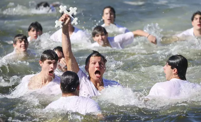 Athos Karistinos, 18, of Tarpon Springs, retrieves the cross from Spring Bayou while participating in the 120th Epiphany celebration on Tuesday, Jan 6, 2026, in Tarpon Springs, Fla. (Jefferee Woo /Tampa Bay Times via AP)