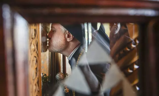 His Eminence Archbishop Elpidophoros of the Greek Orthodox Archdiocese of America venerates an icon moments after arriving at the Saint Nicholas Greek Orthodox Cathedral during the 120th Epiphany celebration on Tuesday, Jan 6, 2026, in Tarpon Springs, Fla. (Jefferee Woo /Tampa Bay Times via AP)