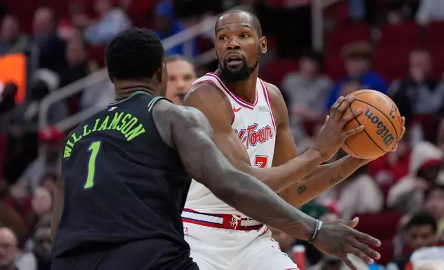 Houston Rockets forward Kevin Durant (7) controls the ball against New Orleans Pelicans forward Zion Williamson (1) during the second half of an NBA basketball game in Houston, Sunday, Jan. 18, 2026. (AP Photo/Ashley Landis)