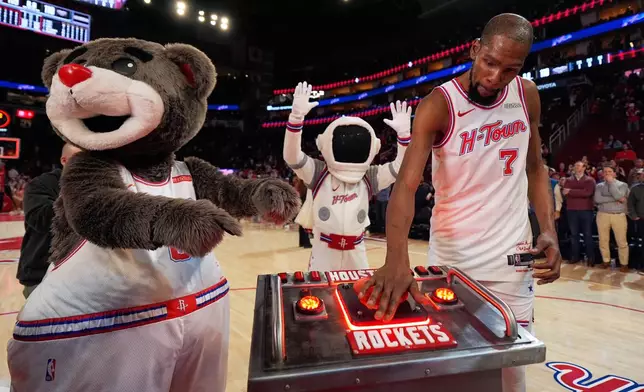 Houston Rockets forward Kevin Durant (7) presses a launch button after surpassing Dirk Nowitzki to become the NBA's sixth all-time leading scorer in an NBA basketball game against the New Orleans Pelicans in Houston, Sunday, Jan. 18, 2026. (AP Photo/Ashley Landis)