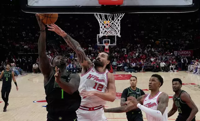 New Orleans Pelicans forward Zion Williamson (1) shoots against Houston Rockets center Steven Adams (12) during the first half of an NBA basketball game in Houston, Sunday, Jan. 18, 2026. (AP Photo/Ashley Landis)