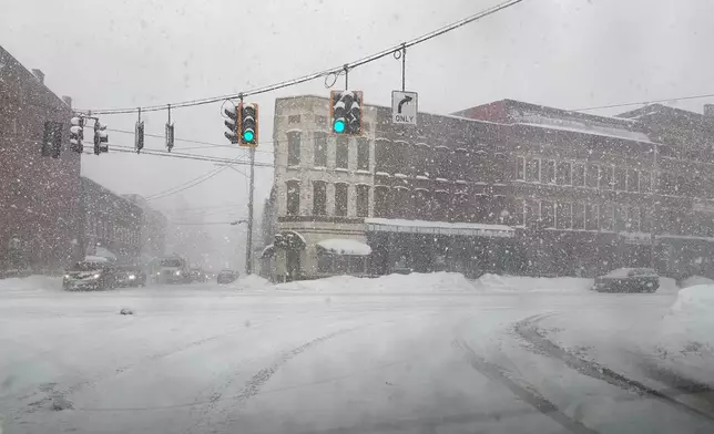 Fresh snow blows through an intersection in Lowville, N.Y., on Thursday, Jan. 22, 2026. (AP Photo/Cara Anna)