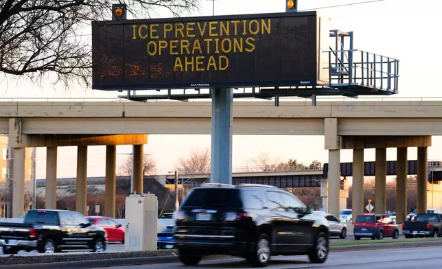 A digital billboard along Highway 75 warns of road preparations for upcoming inclement weather expected in the region Wednesday, Jan. 21, 2026, in Richardson, Texas. (AP Photo/Tony Gutierrez)