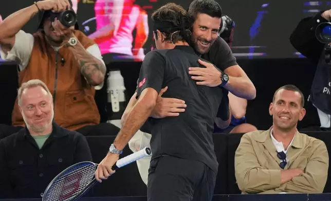 Novak Djokovic, right, of Serbia embraces Roger Federer of Switzerland during the Opening Ceremony for the Australian Open tennis championship in Melbourne, Australia, Saturday, Jan. 17, 2026. (AP Photo/Dita Alangkara)