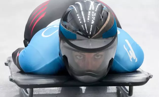 FILE - Janine Flock, of Austria, slides during the women's skeleton run 3 at the 2022 Winter Olympics, Saturday, Feb. 12, 2022, in the Yanqing district of Beijing. (AP Photo/Dmitri Lovetsky, File)