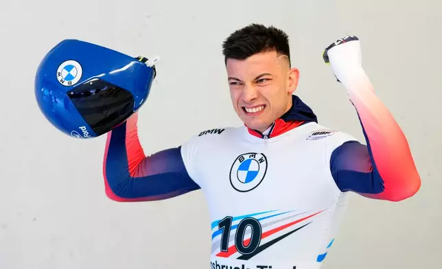 FILE - Matt Weston of Great Britain celebrates after winning the men's skeleton at the Skeleton World Cup race in Igls, near Innsbruck, Austria, Friday, Dec. 15, 2023. (AP Photo/Petr David Josek, File)