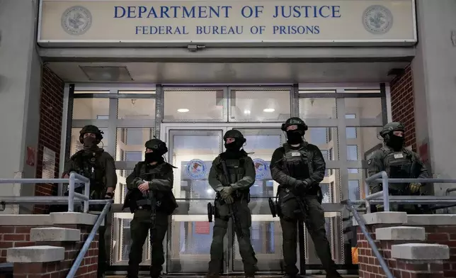 Federal law enforcement personnel stand watch outside the Metropolitan Detention Center as they await the arrival of captured Venezuelan President Nicolas Maduro, Saturday, Jan. 3, 2026, in New York. (AP Photo/Yuki Iwamura)