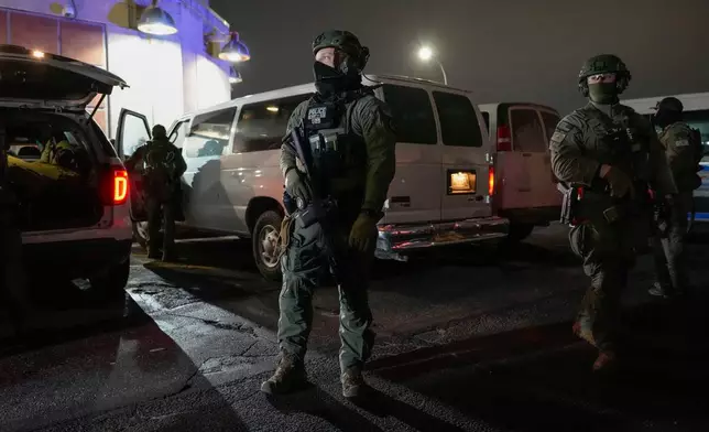 Federal law enforcement personnel patrol outside the Metropolitan Detention Center as they await the arrival of captured Venezuelan President Nicolas Maduro, Saturday, Jan. 3, 2026, in New York. (AP Photo/Yuki Iwamura)