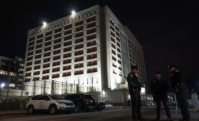 New York Police officers gather outside the Metropolitan Detention Center shortly after the arrival of captured Venezuelan President Nicolas Maduro and his wife Cilia Flores, Saturday, Jan. 3, 2026, in New York. (AP Photo/Yuki Iwamura)