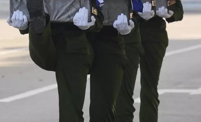 FILE - Soldiers carry urns containing the remains of Cuban officers killed during a U.S. operation in Venezuela that captured President Nicolas Maduro during a funeral in Havana, Cuba, Jan. 16, 2026. (AP Photo/Ramon Espinosa, File)