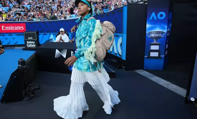 Naomi Osaka of Japan walks onto court for her second round match against Sorana Cirstea of Romaniaat the Australian Open tennis championship in Melbourne, Australia, Thursday, Jan. 22, 2026. (AP Photo/Dita Alangkara)