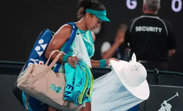 Naomi Osaka of Japan leaves the court after defeating Antonia Ruzic of Croatia in their first round match at the Australian Open tennis championship in Melbourne, Australia, Tuesday, Jan. 20, 2026. (AP Photo/Asanka Brendon Ratnayake)
