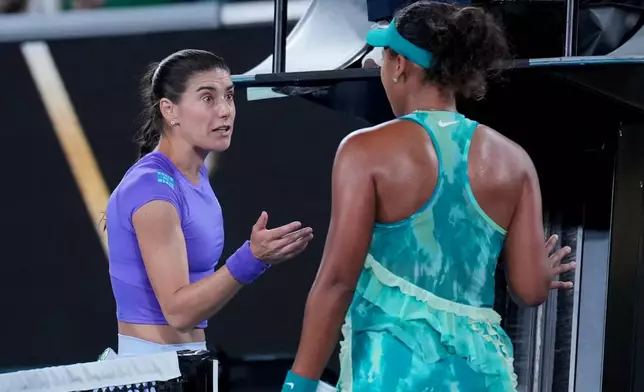 Naomi Osaka, right, of Japan talks with Sorana Cirstea, left, of Romania following their second round match at the Australian Open tennis championship in Melbourne, Australia, Thursday, Jan. 22, 2026. (AP Photo/Dita Alangkara)