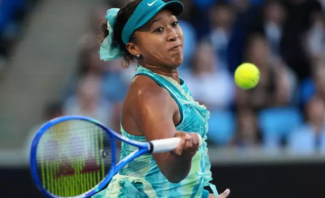 Naomi Osaka of Japan plays a forehand return to Sorana Cirstea of Romania during their second round match at the Australian Open tennis championship in Melbourne, Australia, Thursday, Jan. 22, 2026. (AP Photo/Dita Alangkara)