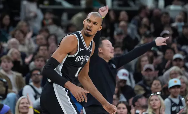 San Antonio Spurs forward Victor Wembanyama (1) reacts after scoring against the Minnesota Timberwolves during the second half of an NBA basketball game in San Antonio, Saturday, Jan. 17, 2026. (AP Photo/Eric Gay)