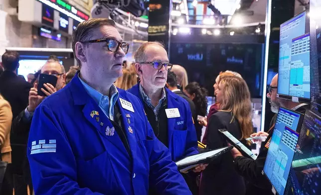 Specialist Patrick King, left, and trader Mark Puetzer work on the floor of the New York Stock Exchange, Wednesday, Jan. 28, 2026. (AP Photo/Richard Drew)