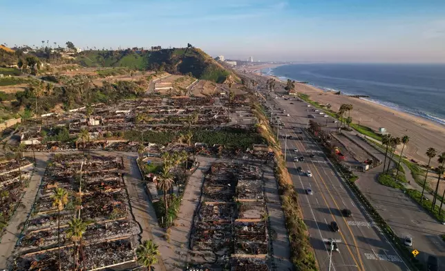 The remains of fire-damaged homes sit in a cleared-out block in the Palisades neighborhood of Los Angeles, Calif., Monday, Dec. 1, 2025. (AP Photo/Annika Hammerschlag)