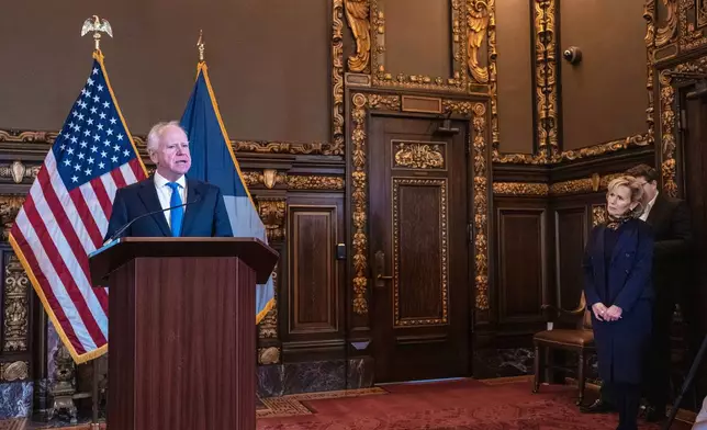 Minnesota Governor Tim Walz, with his wife Gwen Walz looking on announces that he would not be seeking reelection Monday, Jan. 5, 2026 in St. Paul, Minn. (Jerry Holt/Star Tribune via AP)