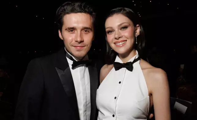 FILE - Brooklyn Beckham, left, and Nicola Peltz attend the Victoria Beckham Spring/Summer 2025 collection presented in Paris on Sept. 27, 2024. (Photo by Vianney Le Caer/Invision/AP, File)